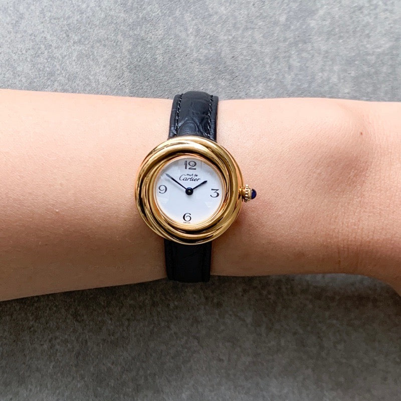 Trinity watch, small model, jumping hour display, Arabic numerals, gold