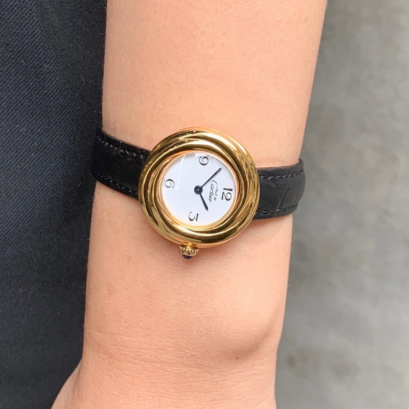 Trinity watch, small model, jumping hour display, Arabic numerals, gold
