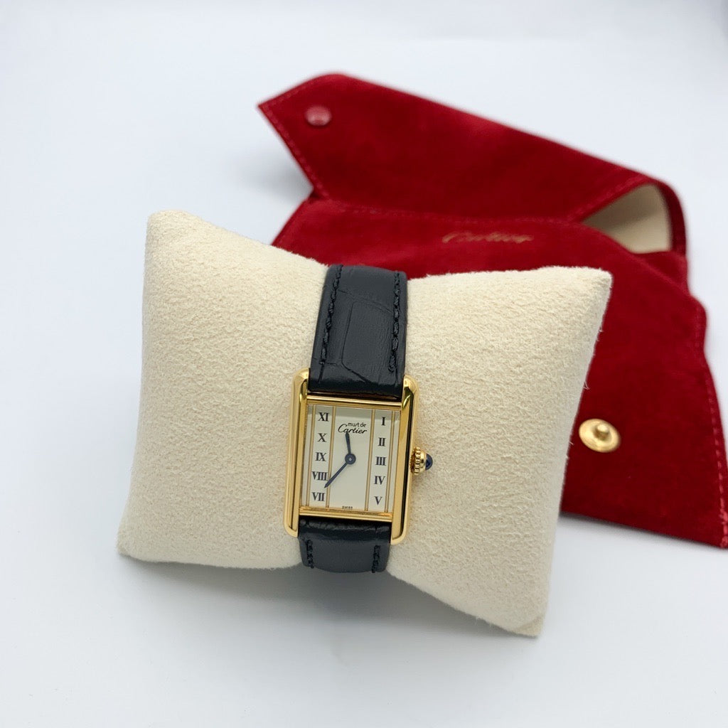Must Tank, small, vertical Roman numeral dial, gold