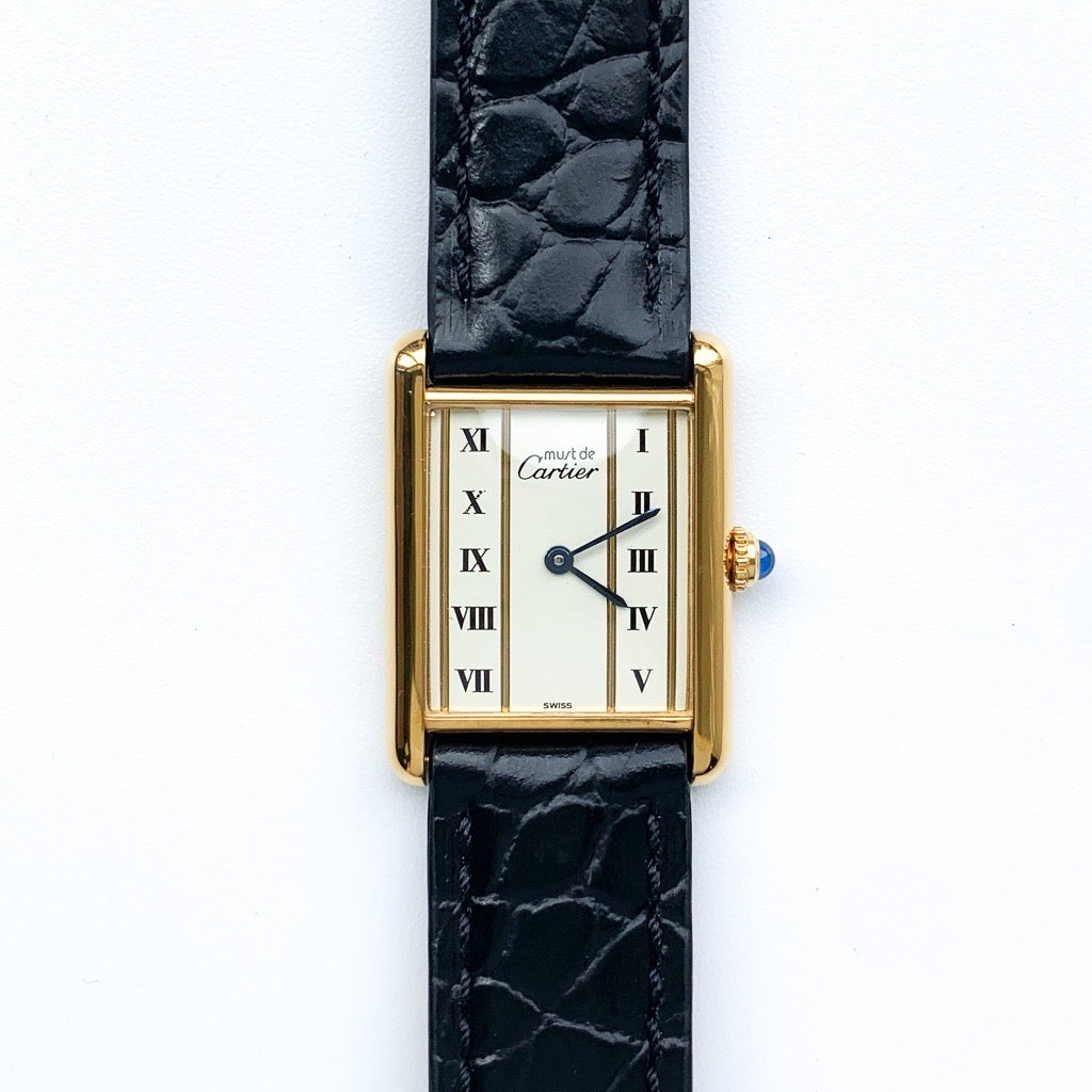 Must Tank LM, vertical Roman numerals, gold dial