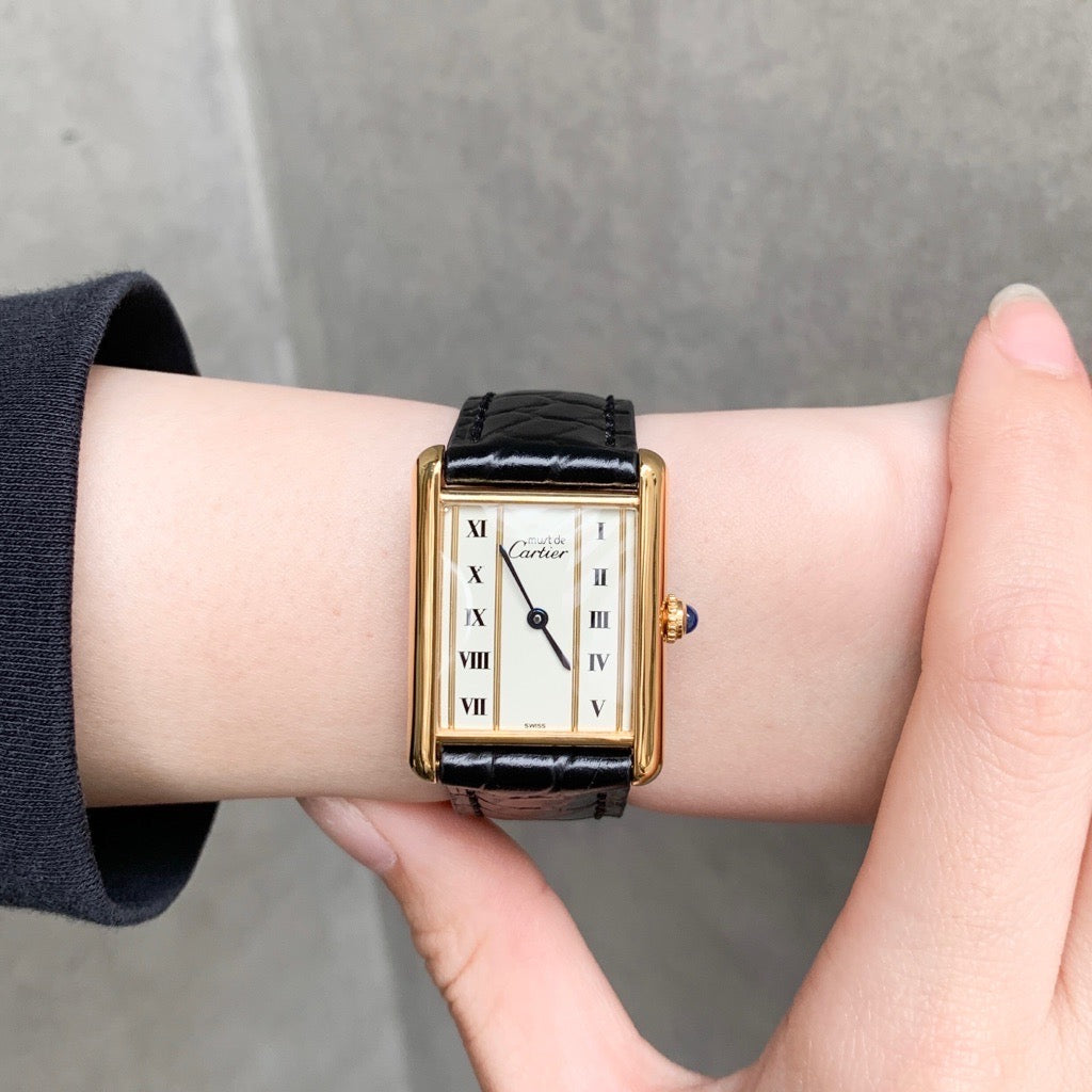 Must Tank LM, vertical Roman numerals, gold dial